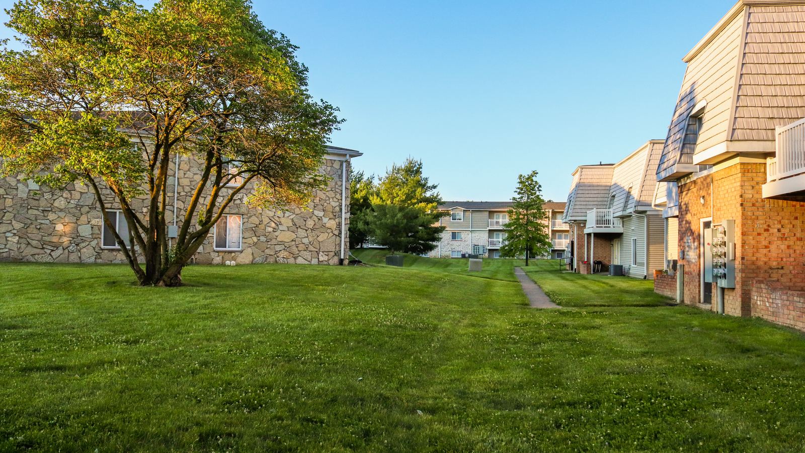 Brick garden-style apartment buildings around a shared lawn