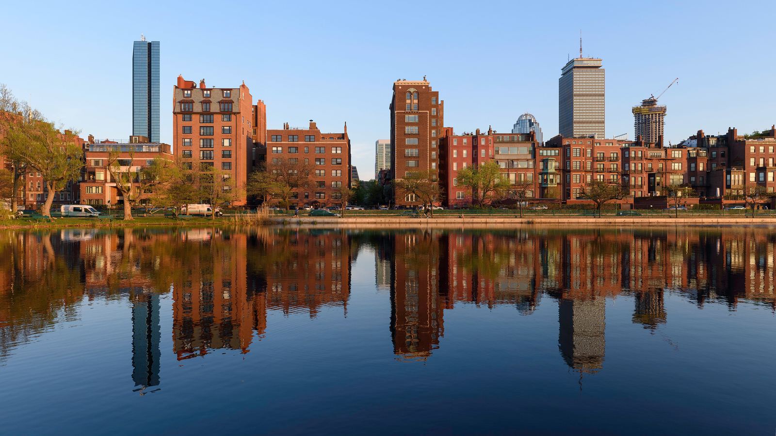 Back Bay row houses and towers reflected in the Charles River in Boston