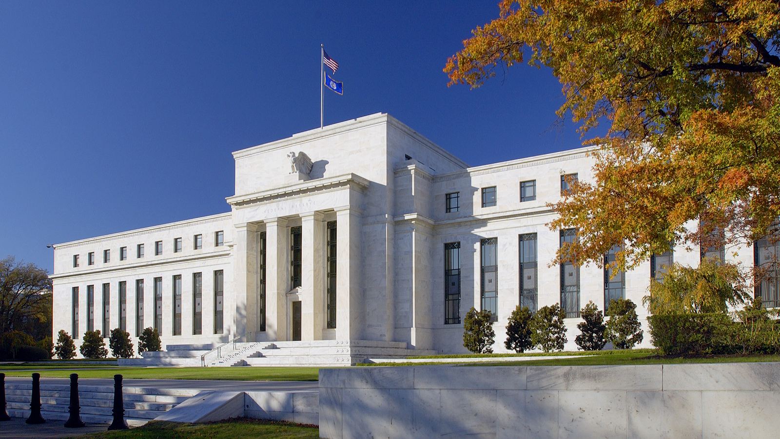 The Federal Reserve's Eccles Building framed by autumn trees