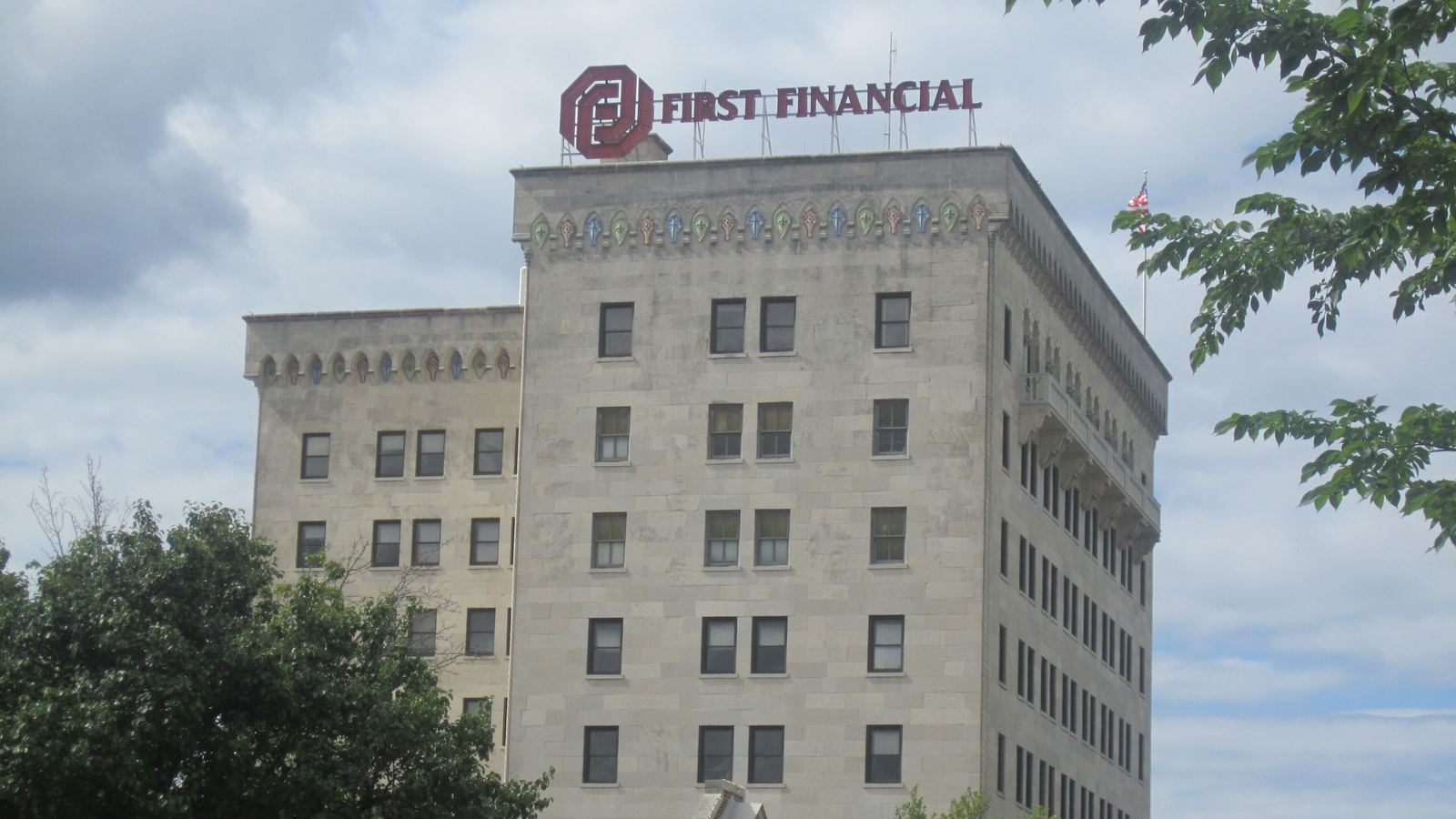 A downtown bank office building with a bank sign on its roof