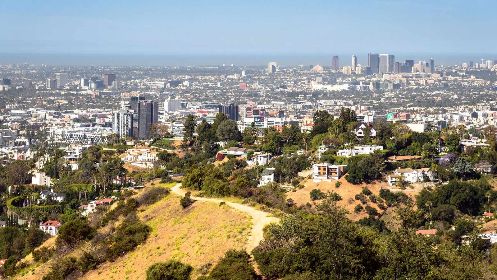 Hillside homes above the Los Angeles basin with downtown towers in the distance