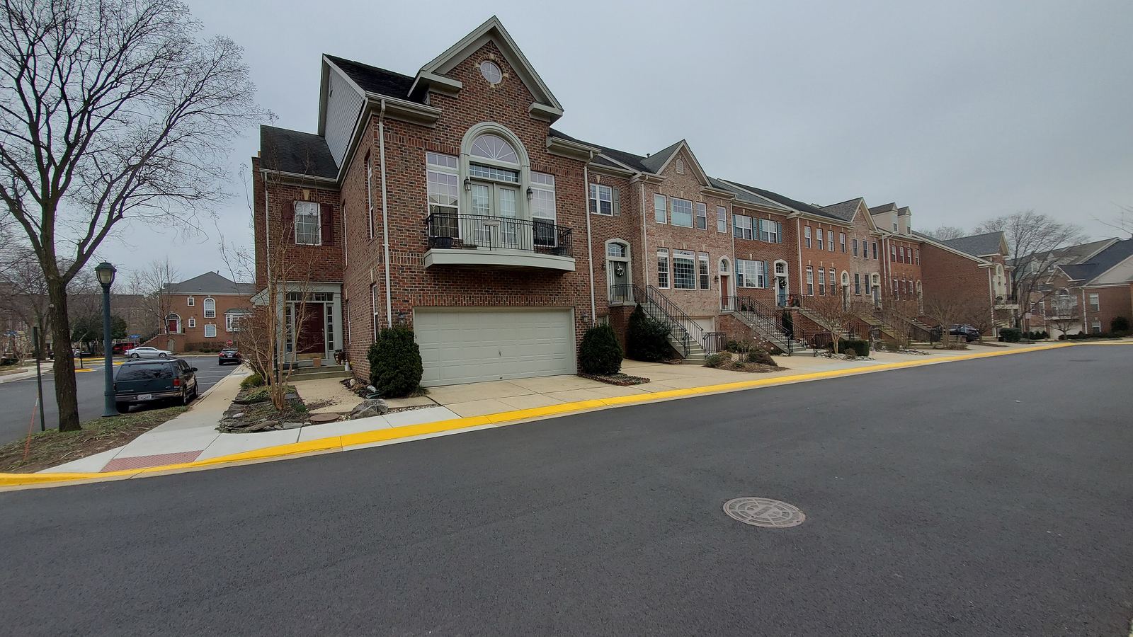 Brick townhomes along a curving suburban street