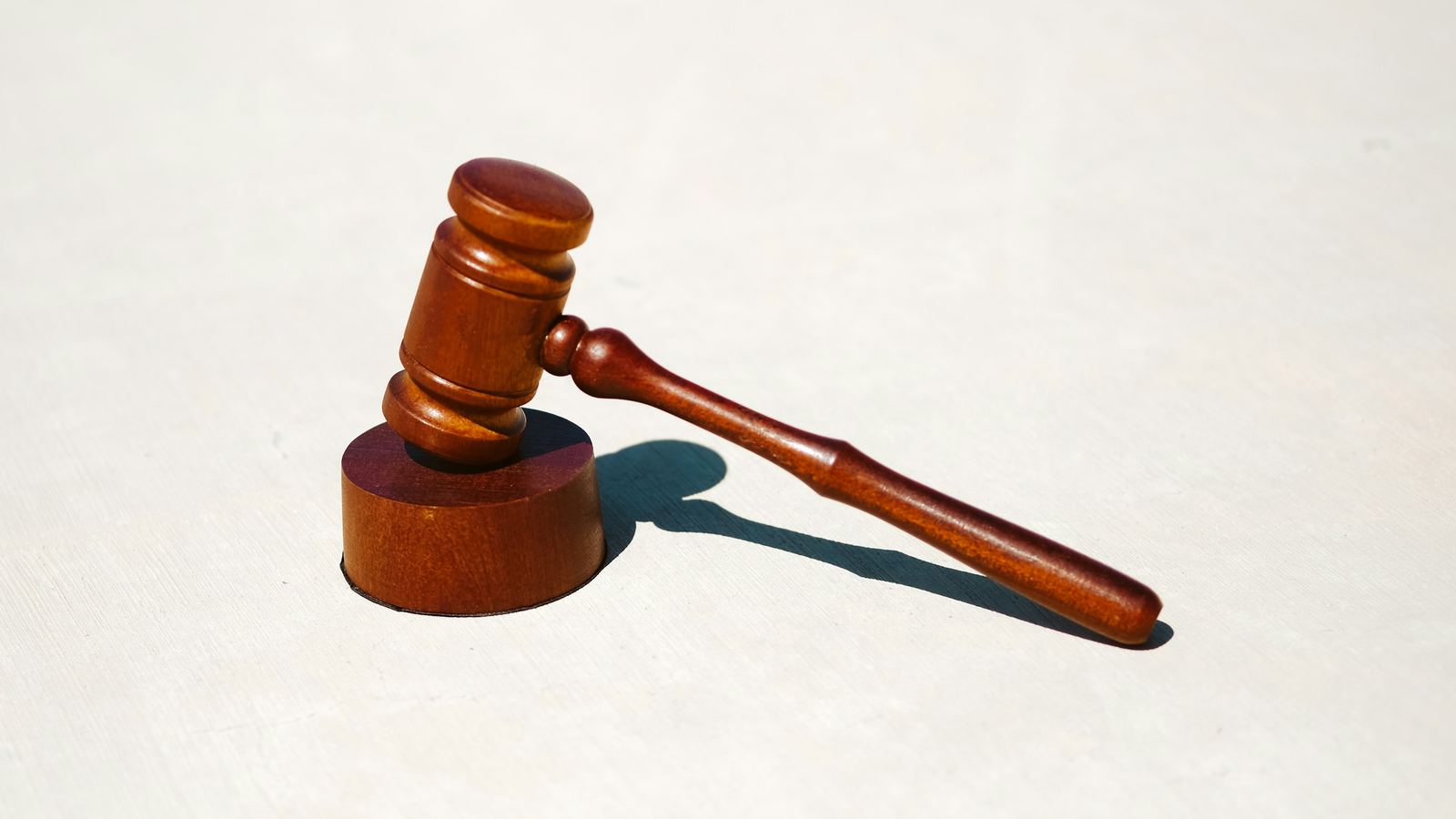 Wooden gavel on a white surface